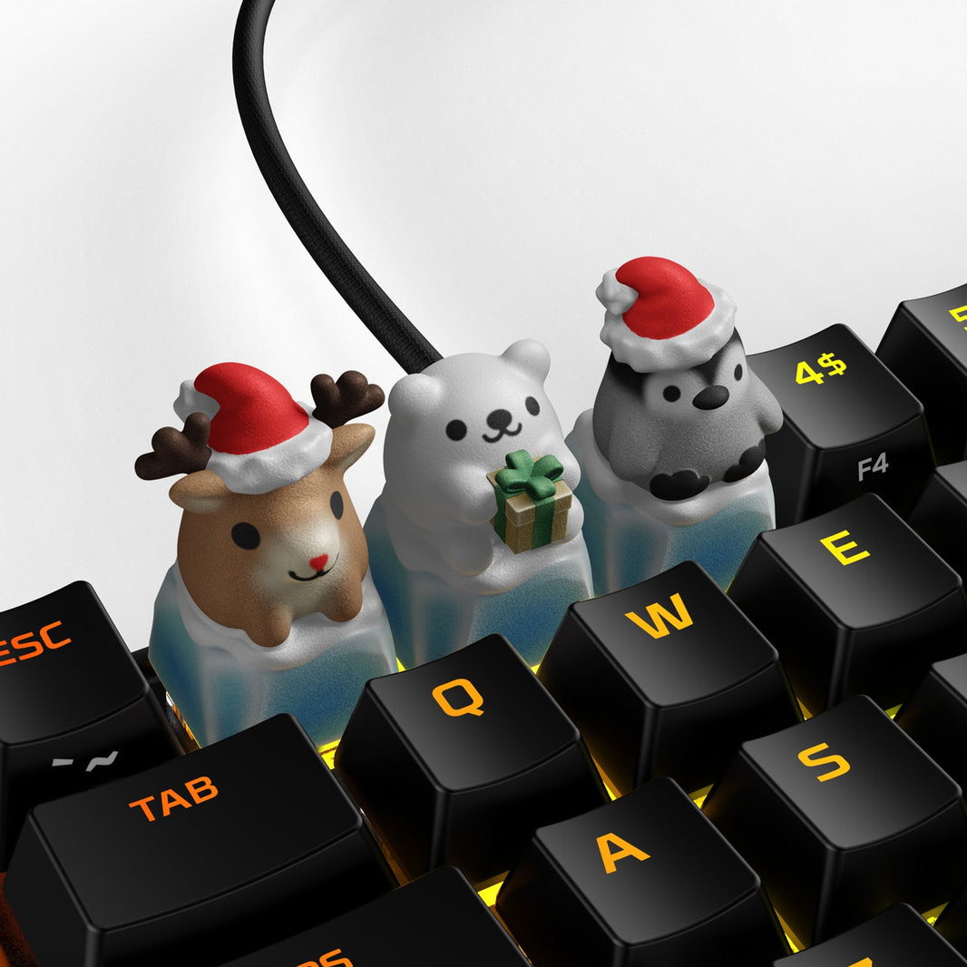 A set of HX3D keycaps featuring holiday-themed characters, including a reindeer and polar bears, placed on a keyboard with illuminated keys.